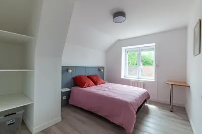 Un ou plusieurs lits dans un hébergement de l'établissement Gîte du Tilleul - Maison climatisée pour 8 voyageurs
