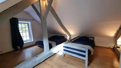 Un ou plusieurs lits dans un hébergement de l'établissement Maison au cœur des Bois