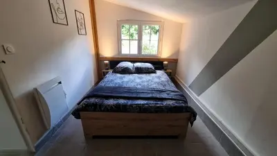 Un ou plusieurs lits dans un hébergement de l'établissement Maison au cœur des Bois