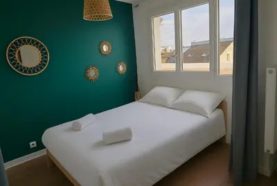 Un ou plusieurs lits dans un hébergement de l'établissement Appartement Spacieux & Parking
