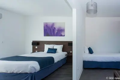 Un ou plusieurs lits dans un hébergement de l'établissement Hotel Libera Caen Colombelles