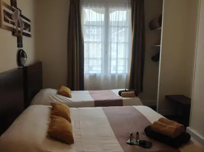 Un ou plusieurs lits dans un hébergement de l'établissement Hotel de la Paix