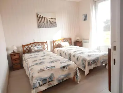 Un ou plusieurs lits dans un hébergement de l'établissement Maison charmante à Portbail avec jardin et vue mer