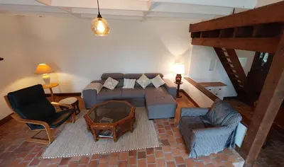Coin salon dans l'établissement Maison La Rivière