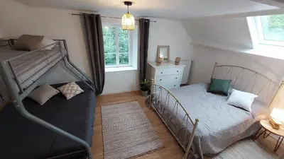 Un ou plusieurs lits dans un hébergement de l'établissement Maison La Rivière