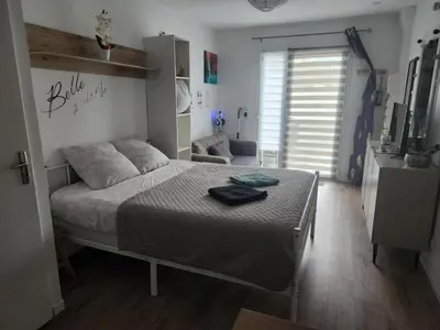Un ou plusieurs lits dans un hébergement de l'établissement Studio Le KA-PHI