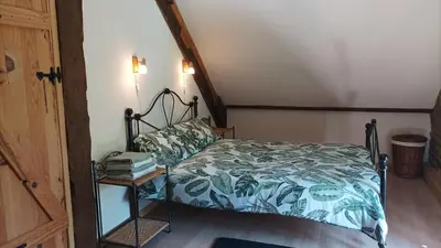 Un ou plusieurs lits dans un hébergement de l'établissement Le Moulin des Hiboux - Gite avec salle de jeux games room