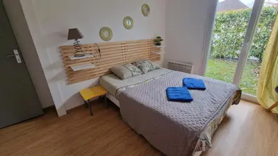 Un ou plusieurs lits dans un hébergement de l'établissement Maison le palmier