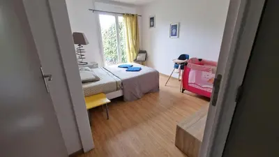 Un ou plusieurs lits dans un hébergement de l'établissement Maison le palmier