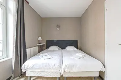 Un ou plusieurs lits dans un hébergement de l'établissement Le nid Saint Jean appartement au coeur de la ville