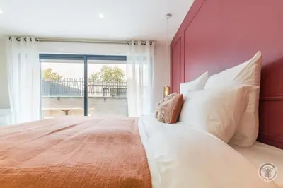 Un ou plusieurs lits dans un hébergement de l'établissement Le Jardin De Marie