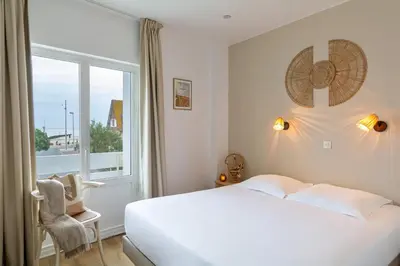 Un ou plusieurs lits dans un hébergement de l'établissement Hôtel De La Plage