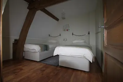 Un ou plusieurs lits dans un hébergement de l'établissement Chambres d'hôtes La Difference-Le Pressoir