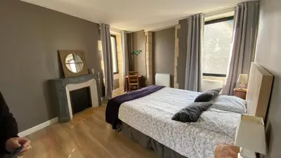 Un ou plusieurs lits dans un hébergement de l'établissement Gîte avec jacuzzi proche de Bayeux