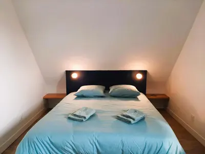 Un ou plusieurs lits dans un hébergement de l'établissement La Belle du bois