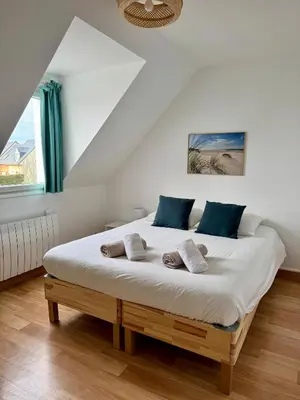 Un ou plusieurs lits dans un hébergement de l'établissement Charmante maison familiale