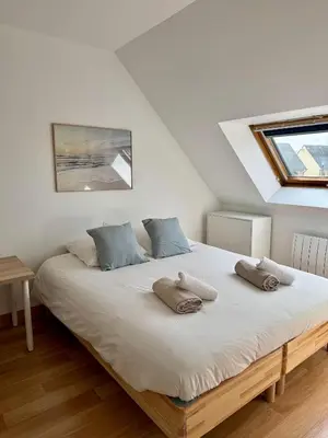 Un ou plusieurs lits dans un hébergement de l'établissement Charmante maison familiale