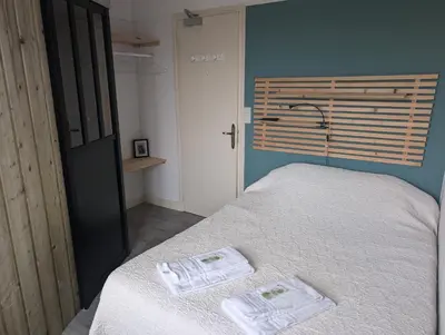 Un ou plusieurs lits dans un hébergement de l'établissement La cocotte normande