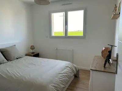 Un ou plusieurs lits dans un hébergement de l'établissement Gîte des couleurs