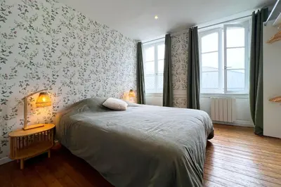 Un ou plusieurs lits dans un hébergement de l'établissement Appart de charme, 2 chambres en centre ville