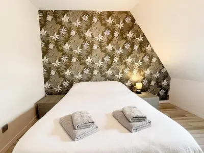 Un ou plusieurs lits dans un hébergement de l'établissement Maison Confortable Proche des Plages