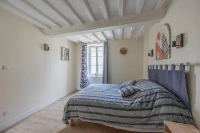 Un ou plusieurs lits dans un hébergement de l'établissement Les Colibris maison en centre-ville