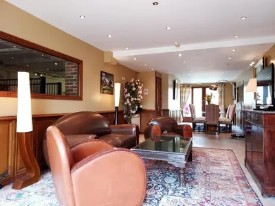 Coin salon dans l'établissement Le Haras des Charmilles