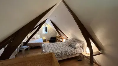 Un ou plusieurs lits dans un hébergement de l'établissement Maisonnette calme