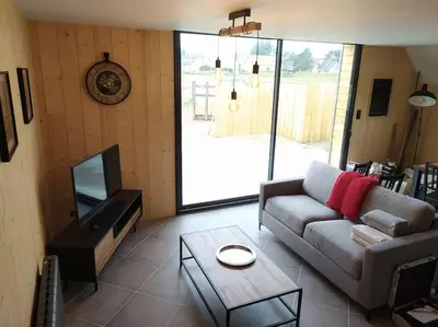 Télévision ou salle de divertissement dans l'établissement Le gîte de la Ferme