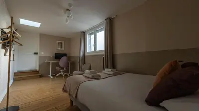 Un ou plusieurs lits dans un hébergement de l'établissement Chambres au coeur du quartier historique - Maison Alternativi
