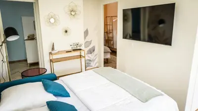 Un ou plusieurs lits dans un hébergement de l'établissement Maison calme éventail de Cabourg