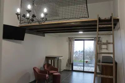 Télévision ou salle de divertissement dans l'établissement Chambre d'hôtes vue sur mer