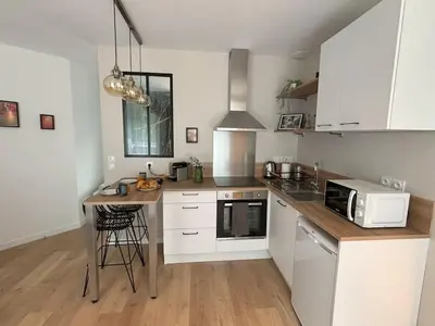 Cuisine ou kitchenette dans l'établissement Studio Titanic Cherbourg Netflix Parking