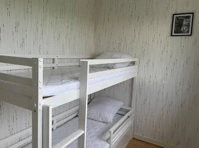 Un ou plusieurs lits dans un hébergement de l'établissement Maison vue sur mer