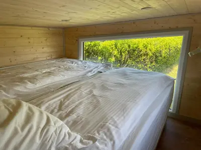 Un ou plusieurs lits dans un hébergement de l'établissement Chalet charmant à Sainte-Marie-du-Mont avec terrasse