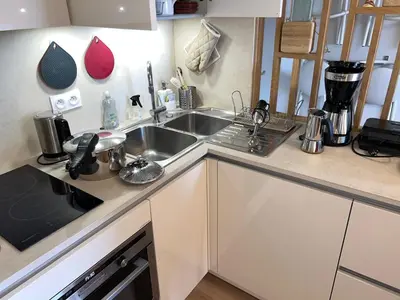 Cuisine ou kitchenette dans l'établissement Les Mimosas -Joli appartement tout confort