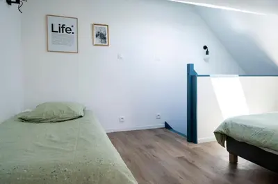 Un ou plusieurs lits dans un hébergement de l'établissement Triplex de qualité, quartier calme