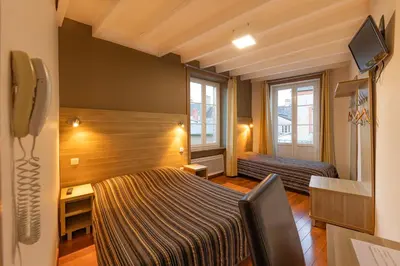 Un ou plusieurs lits dans un hébergement de l'établissement Auberge le John Steele
