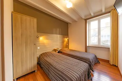 Un ou plusieurs lits dans un hébergement de l'établissement Auberge le John Steele