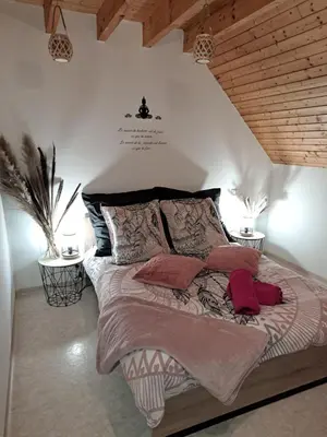 Un ou plusieurs lits dans un hébergement de l'établissement Cottage La Chaumière