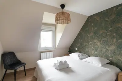 Un ou plusieurs lits dans un hébergement de l'établissement Chez Lisette - Maison climatisée dans Cancale