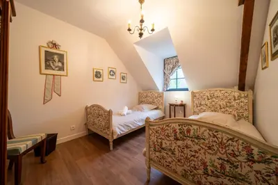 Un ou plusieurs lits dans un hébergement de l'établissement Les calèches de l'Hôtel de Beaumont