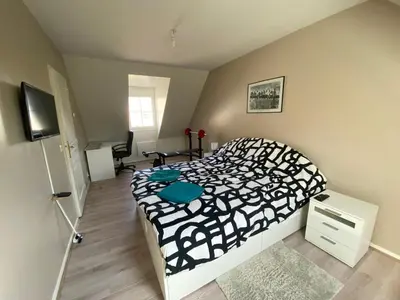 Un ou plusieurs lits dans un hébergement de l'établissement Maison de 100m2 avec jardin aux portes de Caen