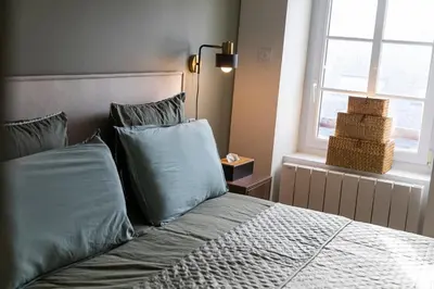 Un ou plusieurs lits dans un hébergement de l'établissement Appartement historique Dior