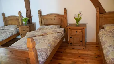 Un ou plusieurs lits dans un hébergement de l'établissement L'Orangerie Normandie