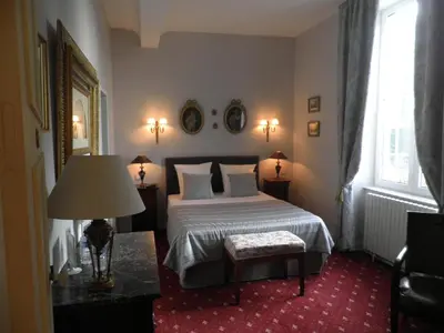 Un ou plusieurs lits dans un hébergement de l'établissement Victoria Arromanches B&B