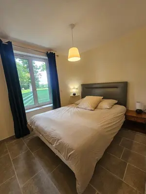 Un ou plusieurs lits dans un hébergement de l'établissement Gîte le bûcher du château