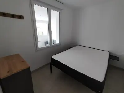Un ou plusieurs lits dans un hébergement de l'établissement Maison de vacances à la plage