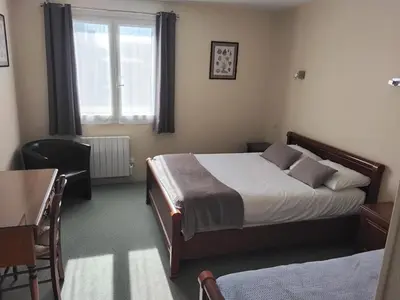 Un ou plusieurs lits dans un hébergement de l'établissement La Grandcopaise Chambres et Studios