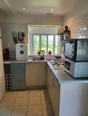 Cuisine ou kitchenette dans l'établissement MAISONS Capucine et Rose